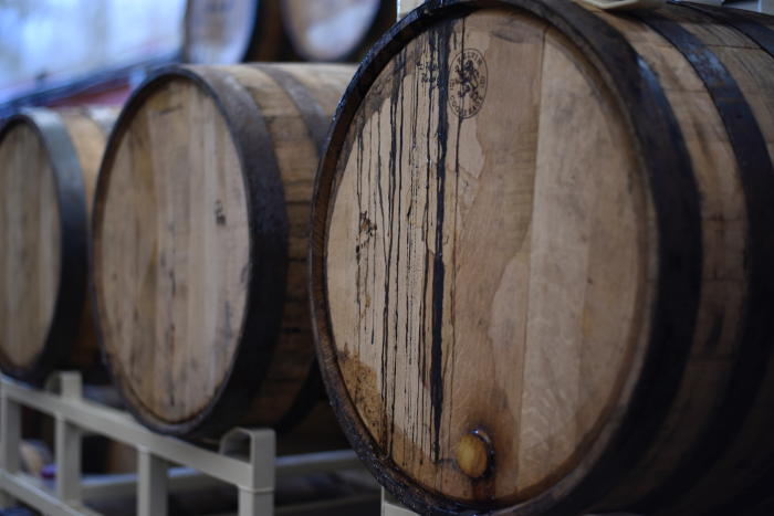 Old barrels stacked in containers in the cellar. Photo by Elevate from Pexels.