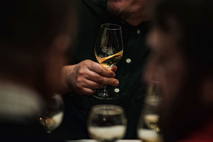 Person holding glass of ice wine