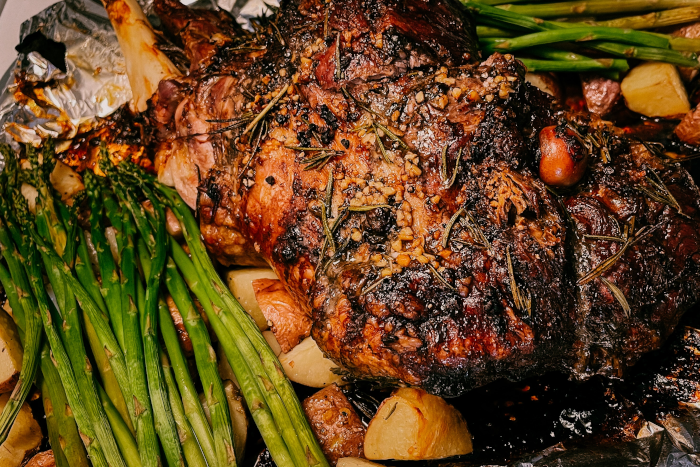 Easter Dinner, Roasted Lamb Leg, Potatoes, Asparagus, and Olive Oil. Photo by Ben Libby from Unsplash.