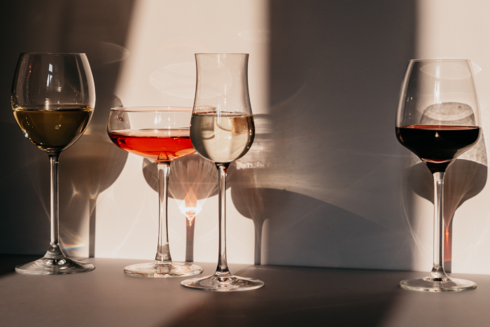 Different sorts of wine in various glasses on table in sunlight. Foto by Polina Kovaleva from Pexels. 