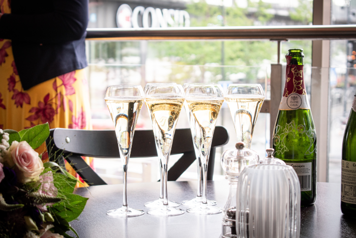 Glasses full of cava on the table. Photo by Maria Petersson from Unsplash.